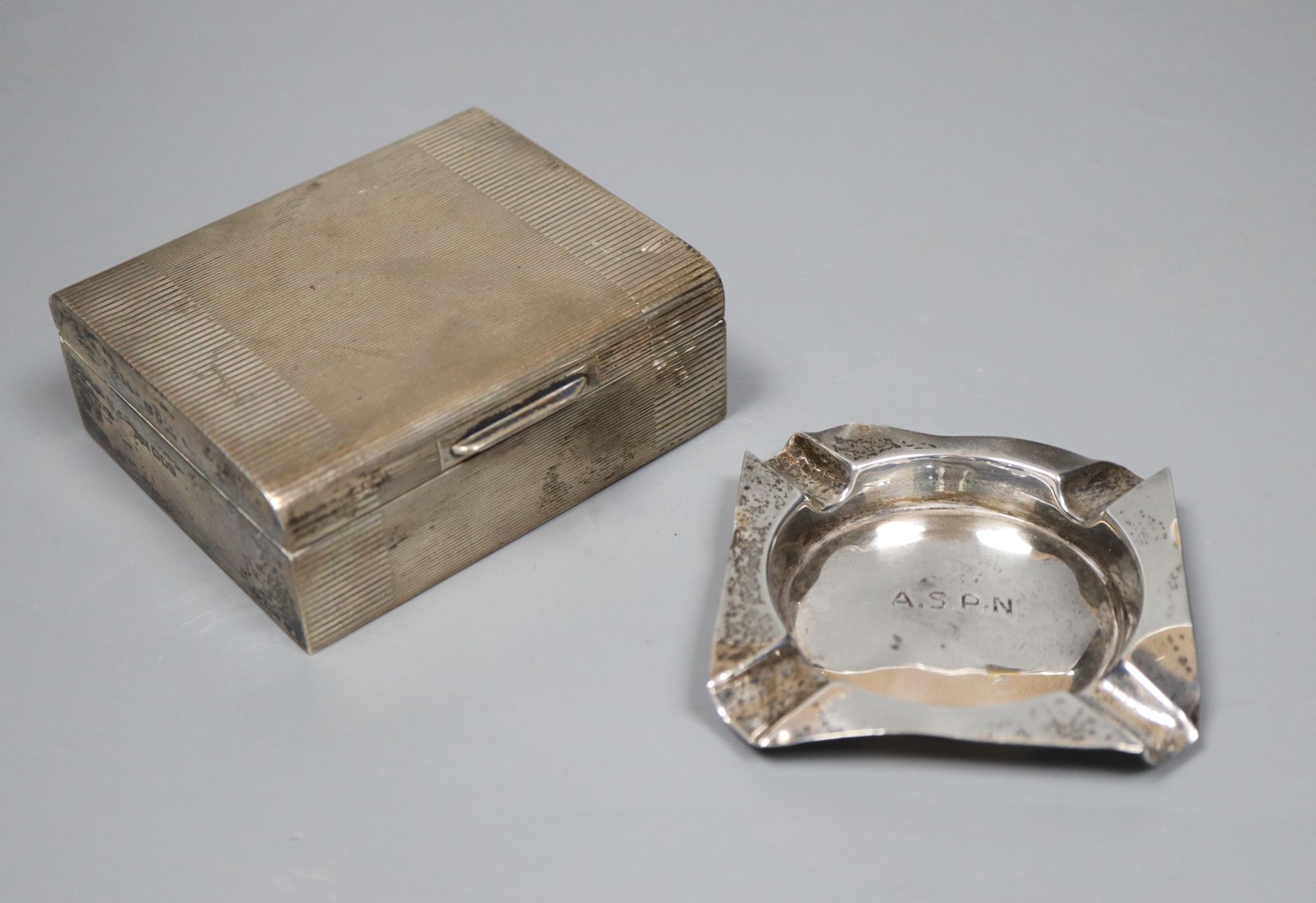 A small Edwardian silver cigarette box, 87mm and a small silver ashtray.